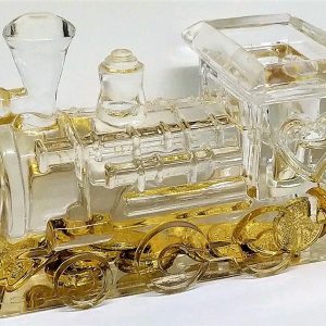 LOCOMOTORA TRANSPARENTE CON MONEDAS EN EL INTERIOR.